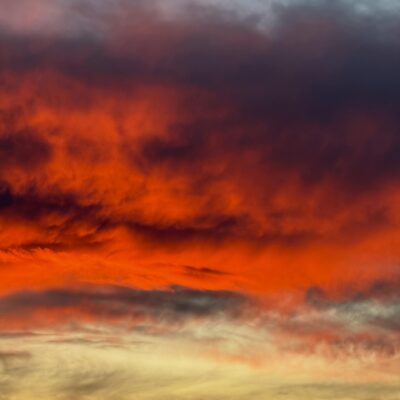 Vibrant red and orange sunset clouds create a dramatic atmosphere.